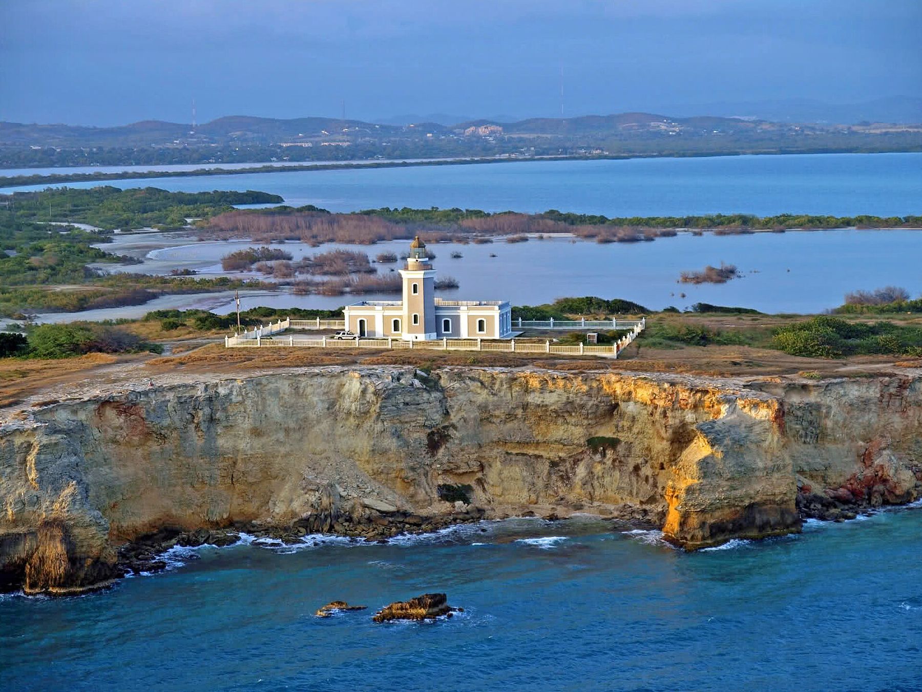 The Los Morrillos lighthouse on limestone cliffs above the sea at Cabo Rojo