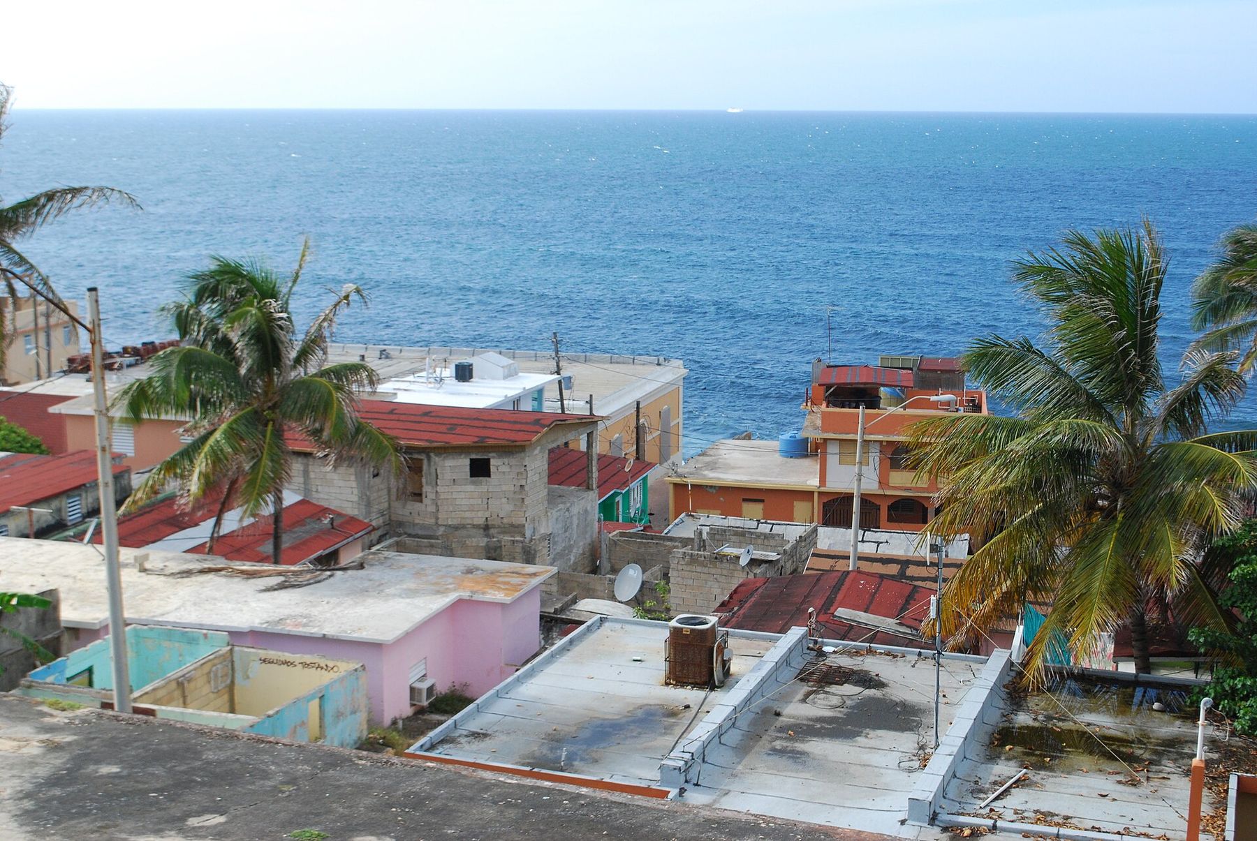 Painted houses of La Perla below the wall of Old San Juan with the Atlantic behind